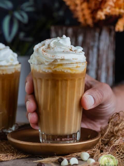 Vegan White Chocolate Mocha Latte topped with whipped cream and cinnamon.