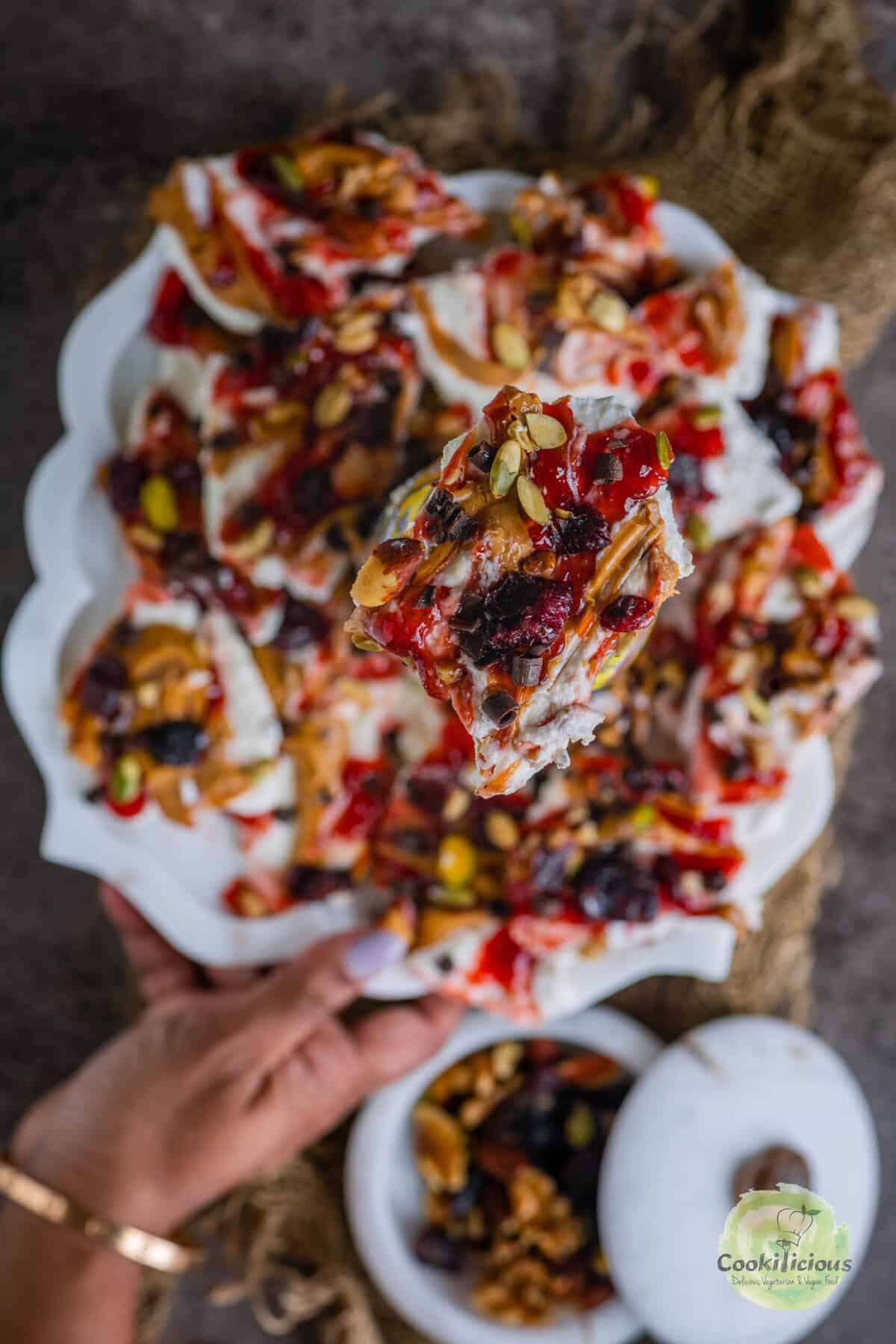 Close-up of high-protein frozen cottage cheese dessert with colorful toppings and chocolate curls.