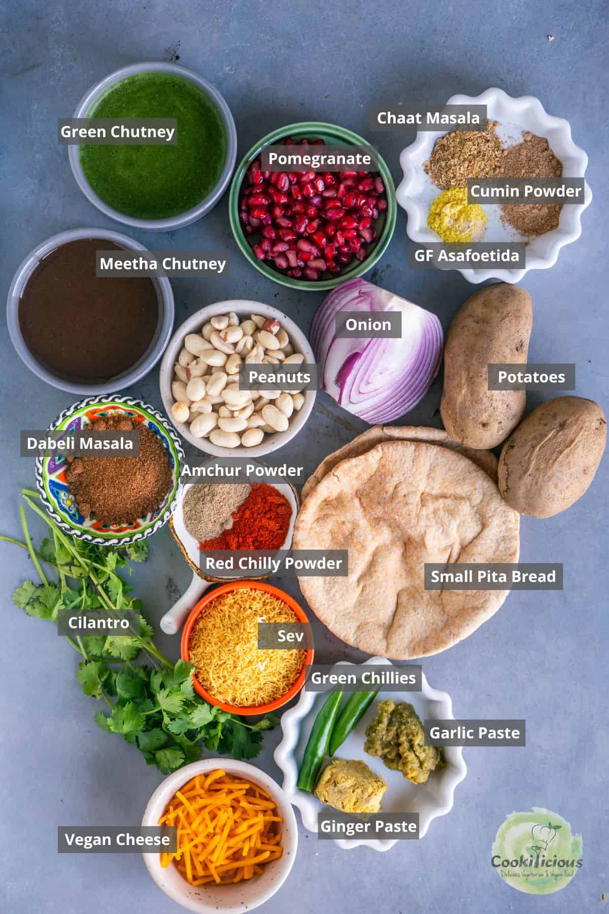 all the ingredients needed to make Indian vegan dabeli pizza placed on a table with labels on them.
