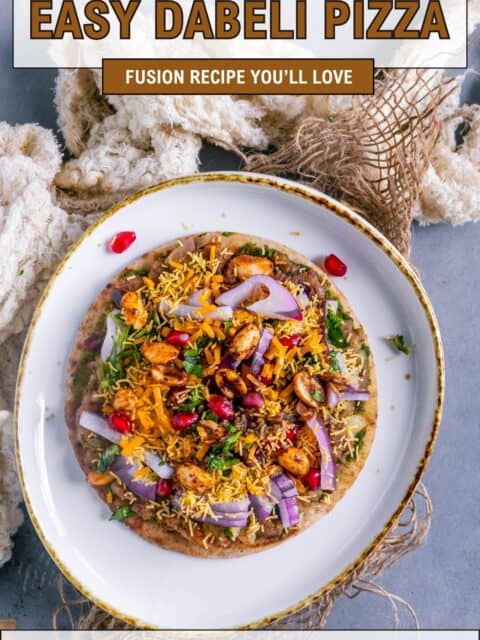 Easy Dabeli Pizza recipe with mini pita bread, flavorful dabeli masala, crunchy sev, pomegranate, and cheese – perfect fusion snack and text at the top and bottom.