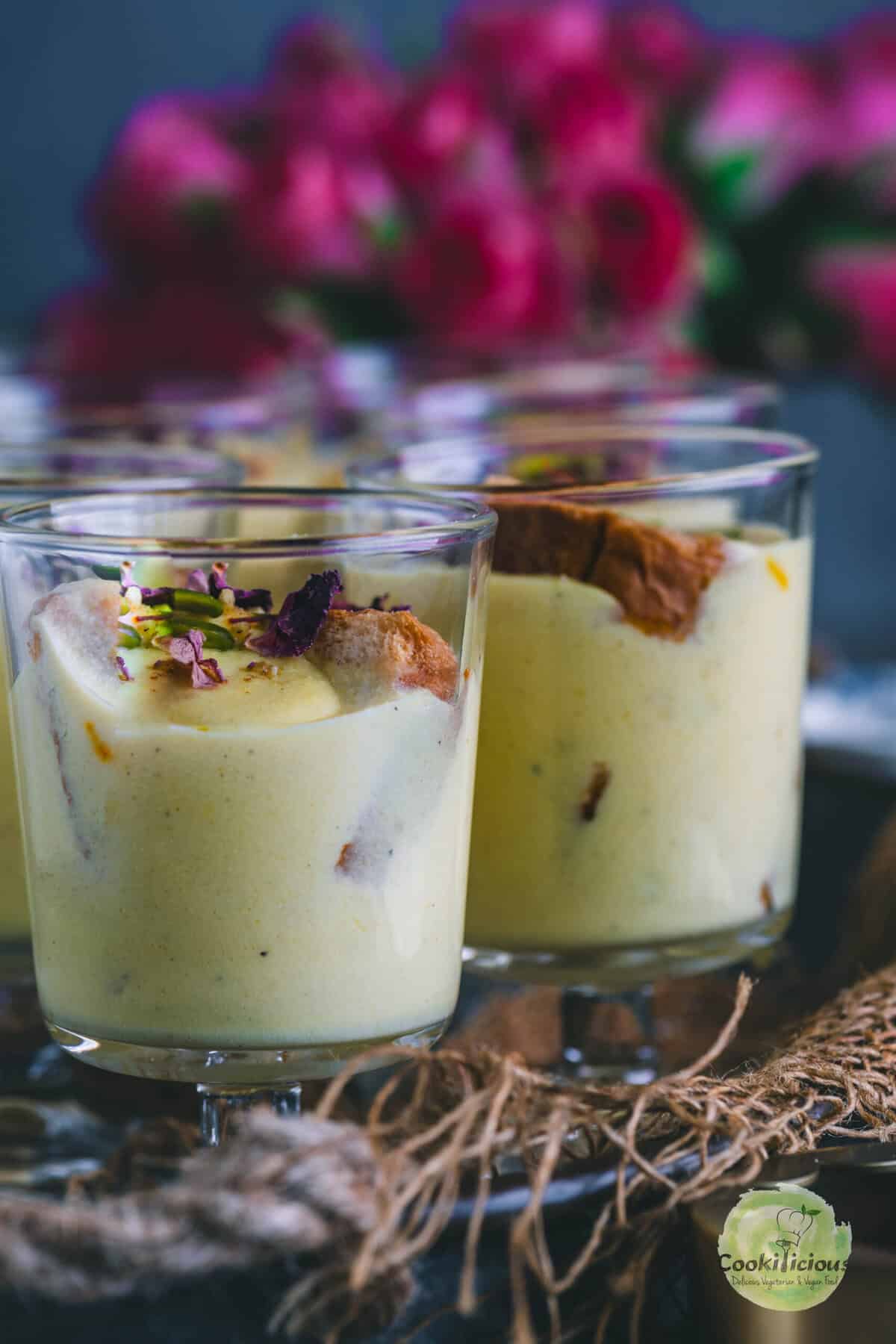 Instant Rabdi Cheesecake topped with saffron strands and pistachios — a creamy Indian fusion dessert made with ricotta cheese and a crunchy rusk base.