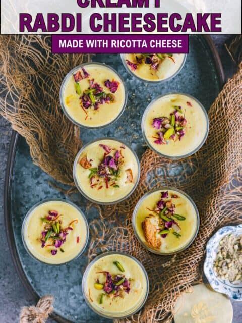 Plated Rabdi Cheesecake ready for Diwali or festive celebrations, topped with pistachios, saffron, and almonds and text at the top and bottom.