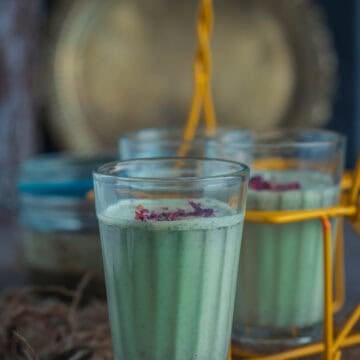 Refreshing Meetha Paan Shots in small glasses with gulkand and green paan leaves, homemade Indian dessert drink.