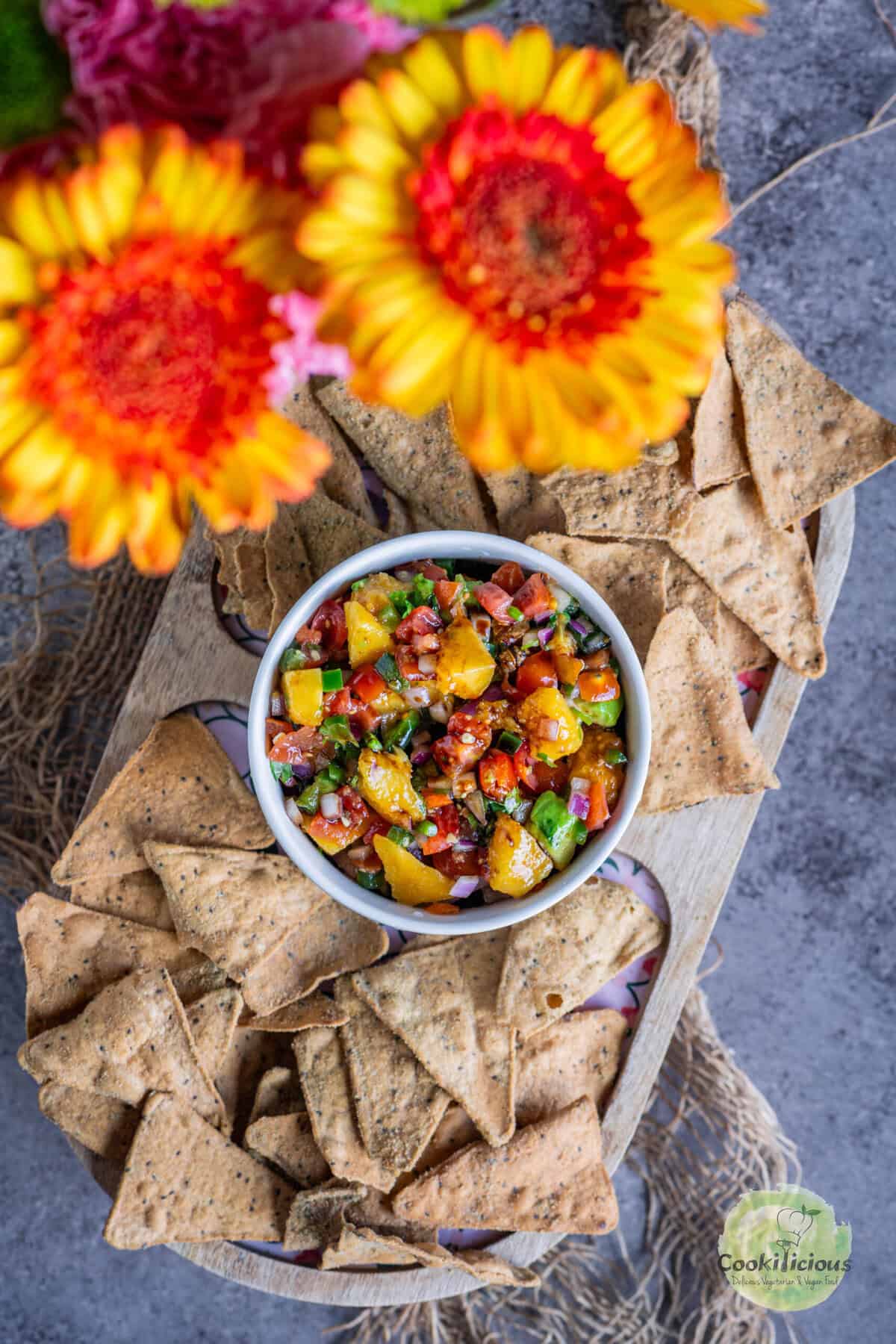 Close-up of fresh peach salsa dip in a bowl with tortilla chips, colorful and vibrant.