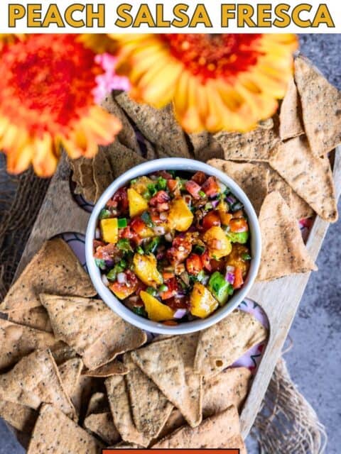 Bowl of zesty peach salsa dip served with tortilla chips ready to serve and text at the top and bottom.