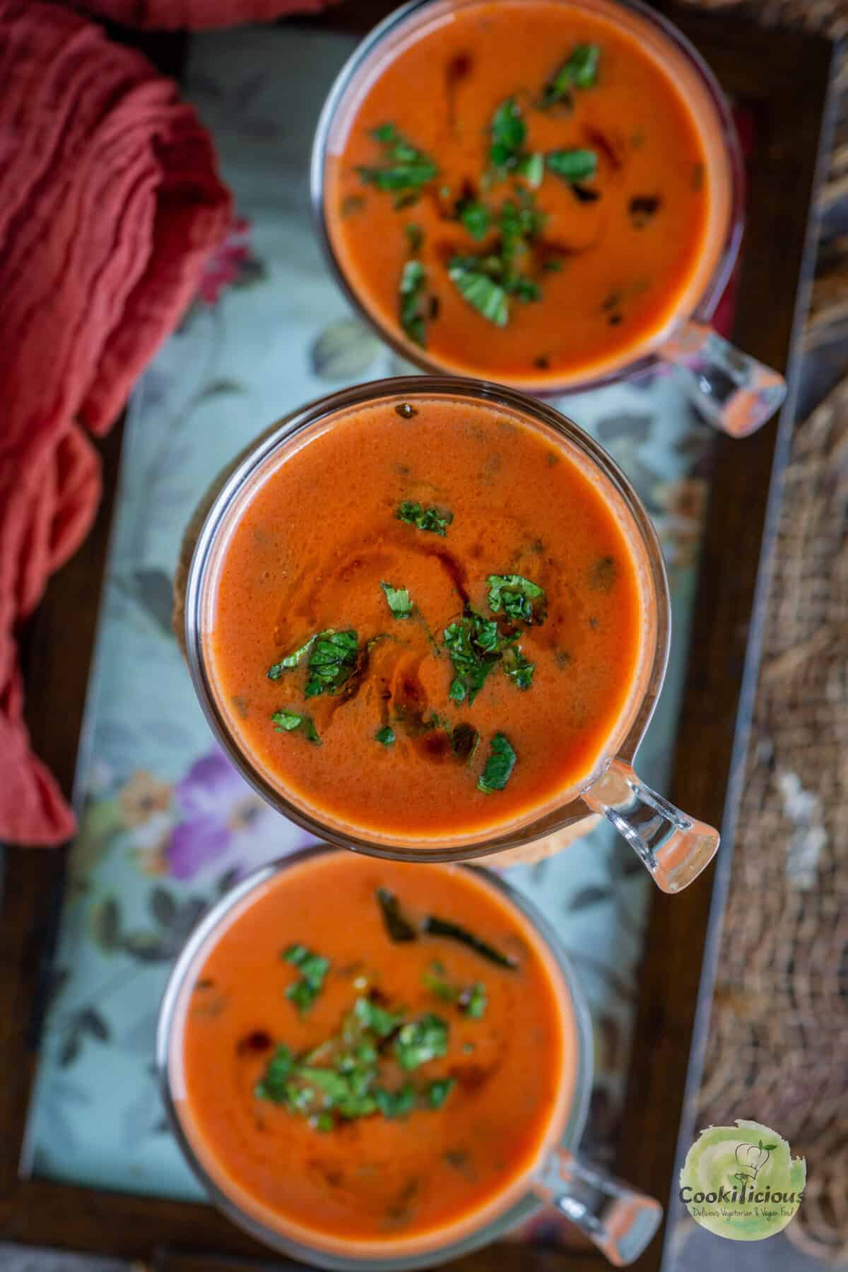 Close-up of creamy vegan tomato drink garnished with cilantro – Maharashtrian Tomato Saar recipe.