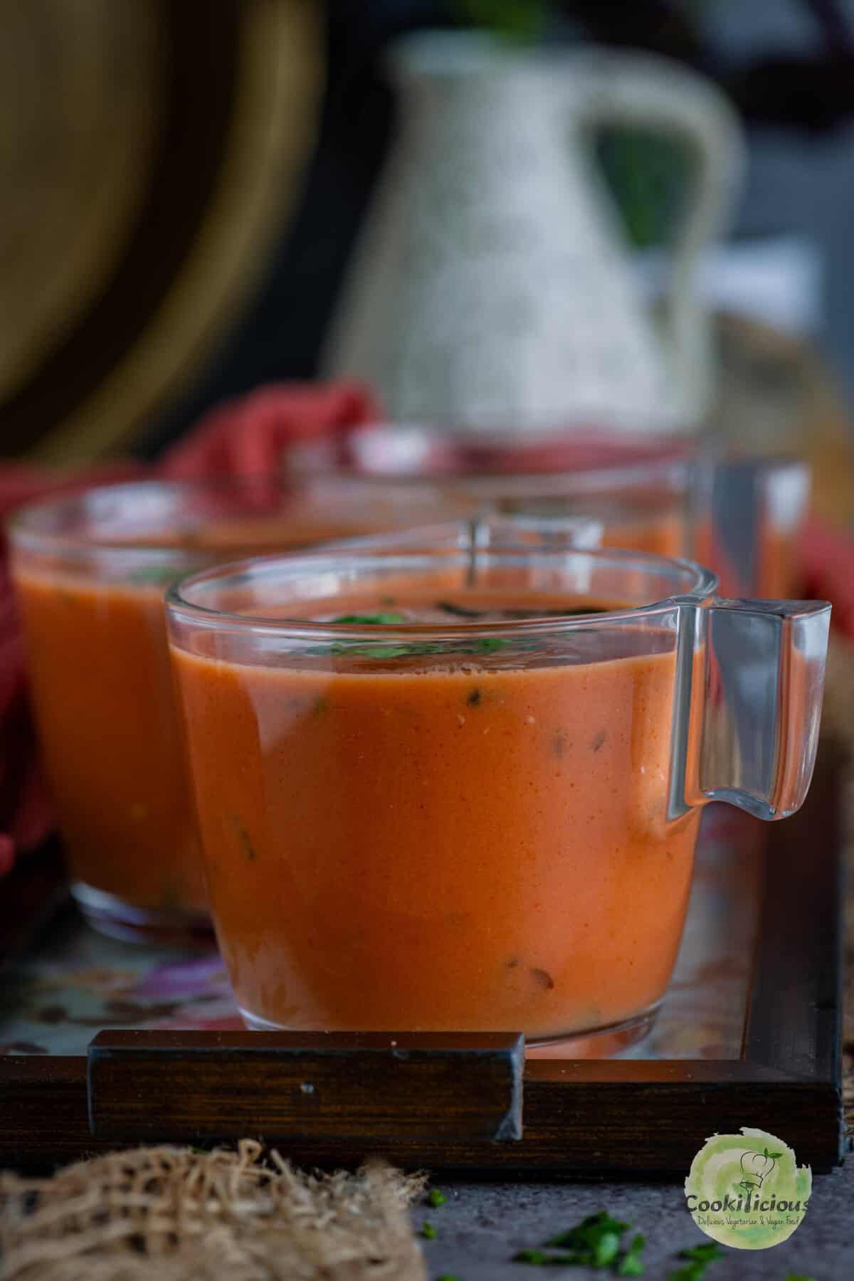 Warm Tomato Saar in a bowl with curry leaves and cumin seeds – traditional Indian tomato drink.