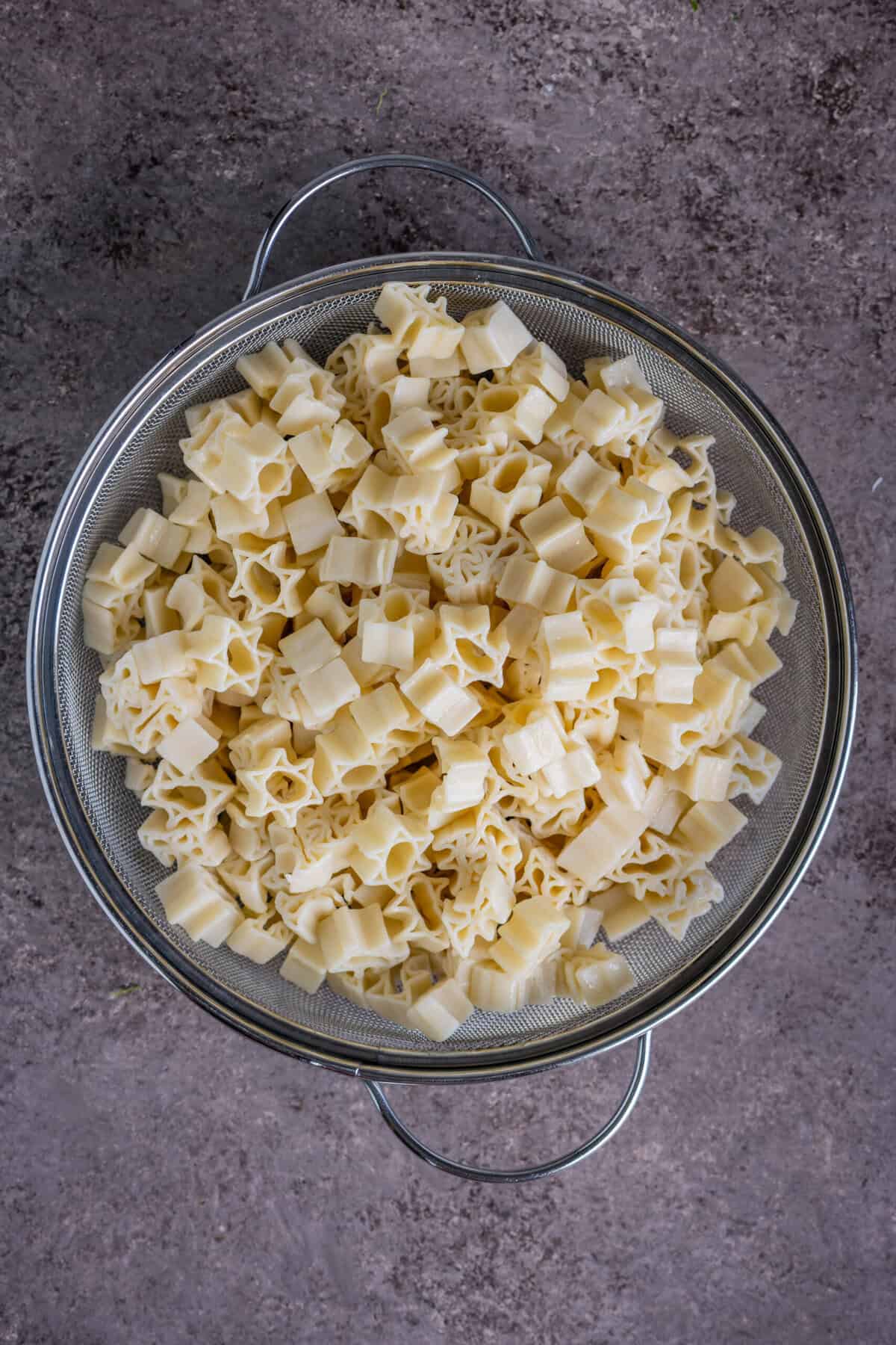 Boiling pasta in salted water until al dente for the vegan breadcrumbs pasta recipe.