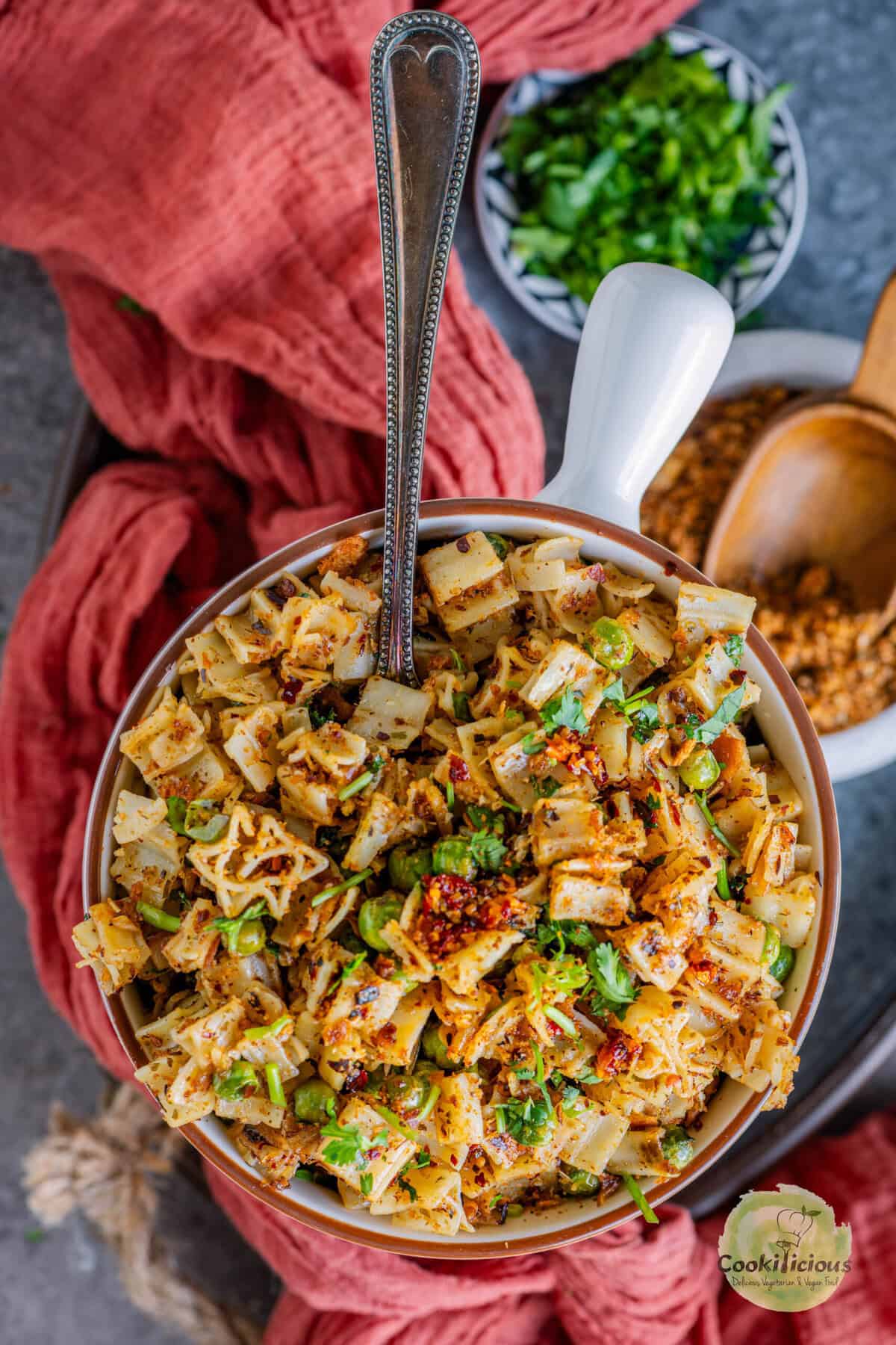 Bowl of pasta with breadcrumbs topped with golden garlic pangrattato and fresh herbs.