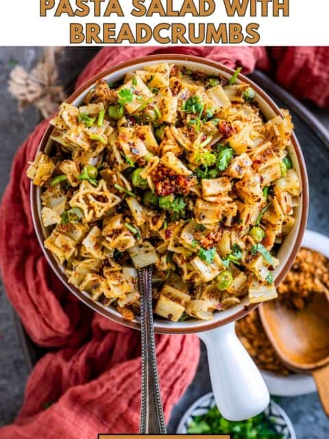 Toasted garlic breadcrumbs sprinkled over cooked pasta and text at the top and bottom.