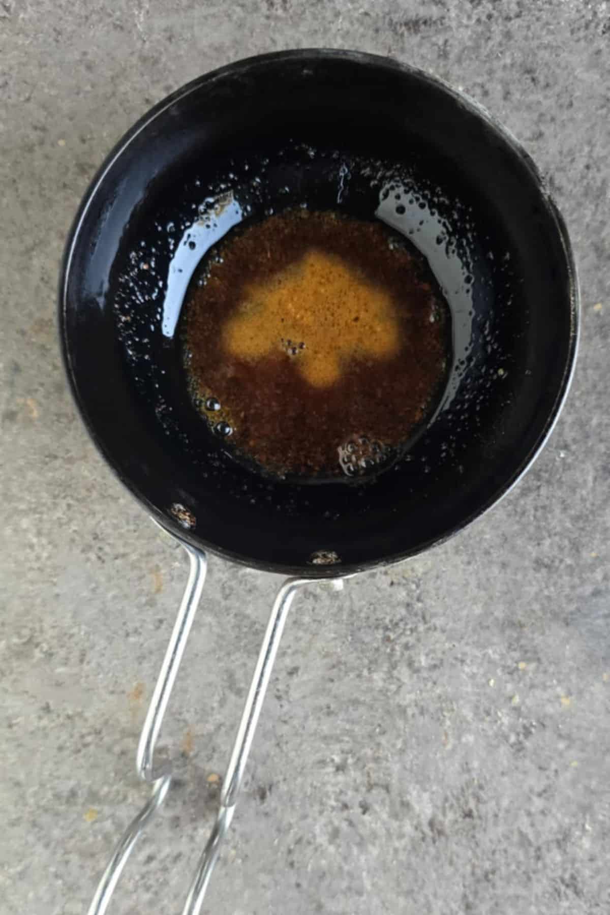 Prepare a Hot tempering of vegan ghee, red chili powder, and hing.