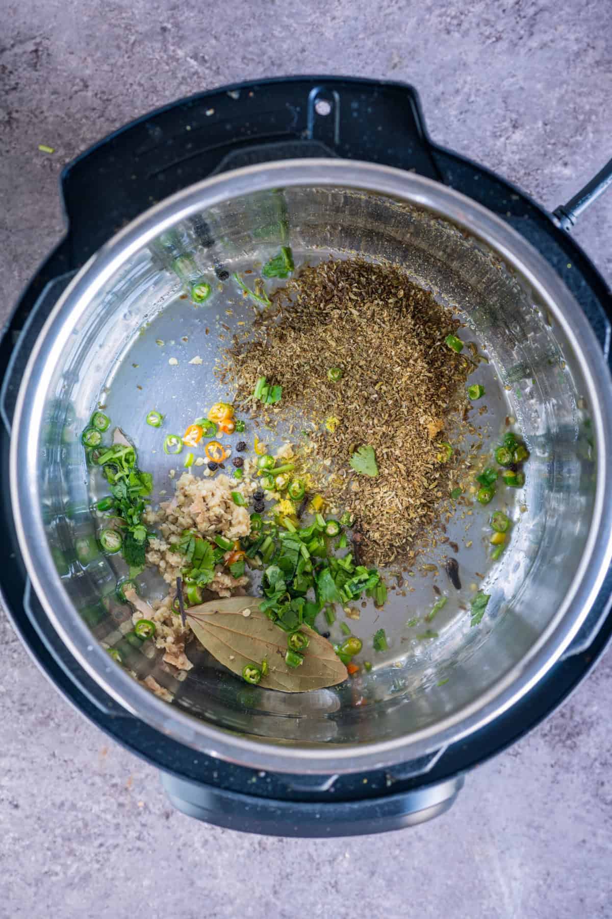 Then cilantro stalks are being sautéed in vegan ghee inside an Instant Pot to form the aromatic base of rasedar aloo curry.