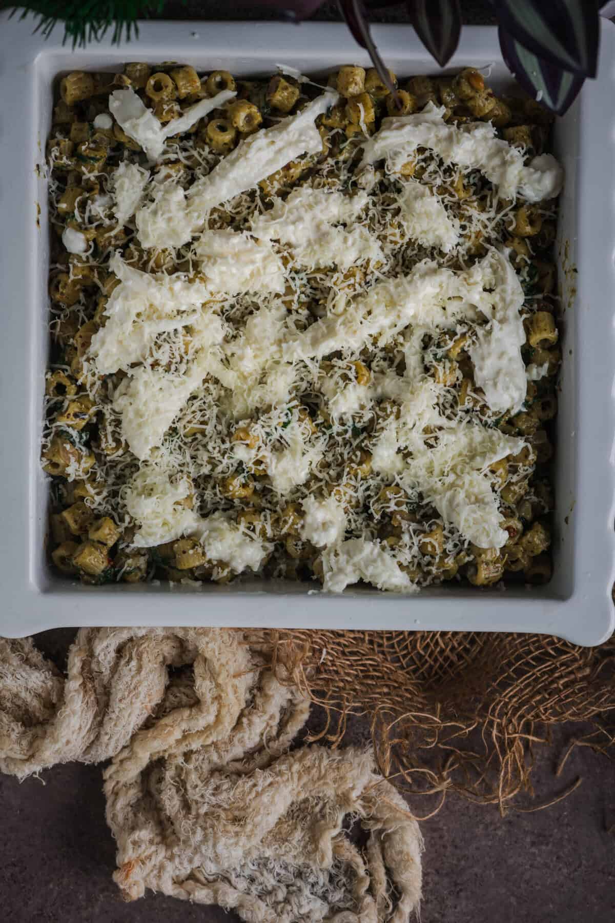 Mozzarella and burrata layered over the pasta before baking.
