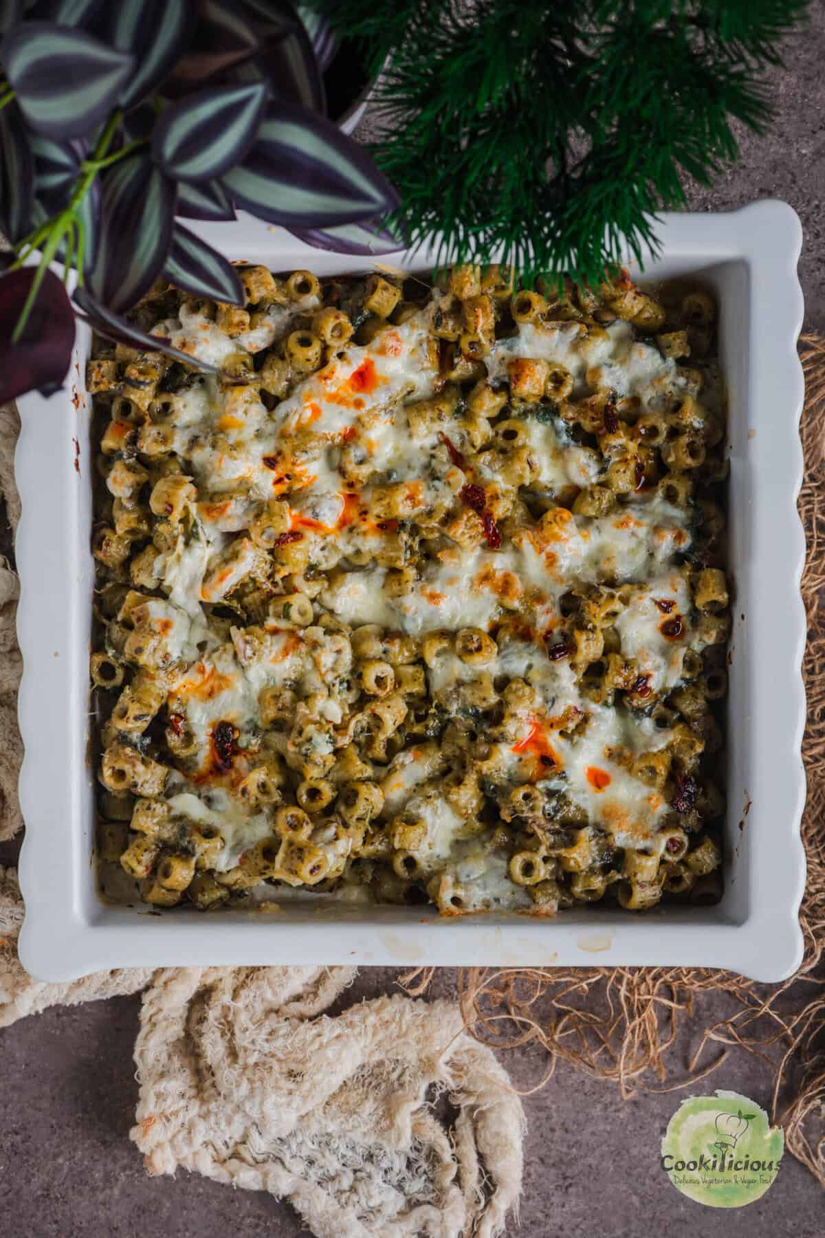 Finished pesto pasta bake ready to serve, hot and cheesy.