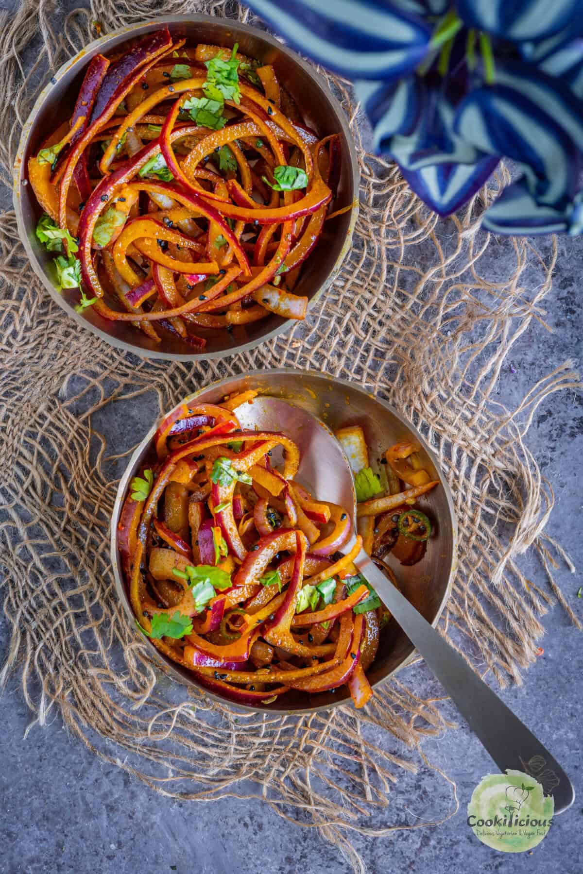 Vegan Indian onion salad made with red onions and spices, served in two bowls.
