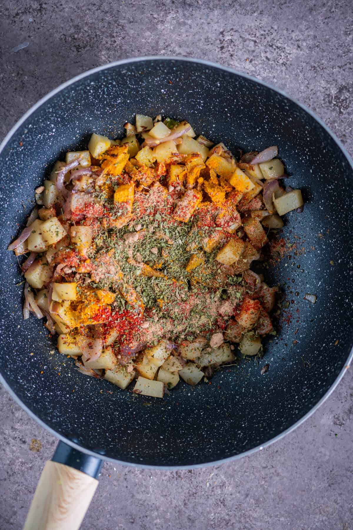 Turmeric, coriander, cumin, red chili powder, amchur powder, and crushed kasuri methi added to potatoes for rich flavor.
