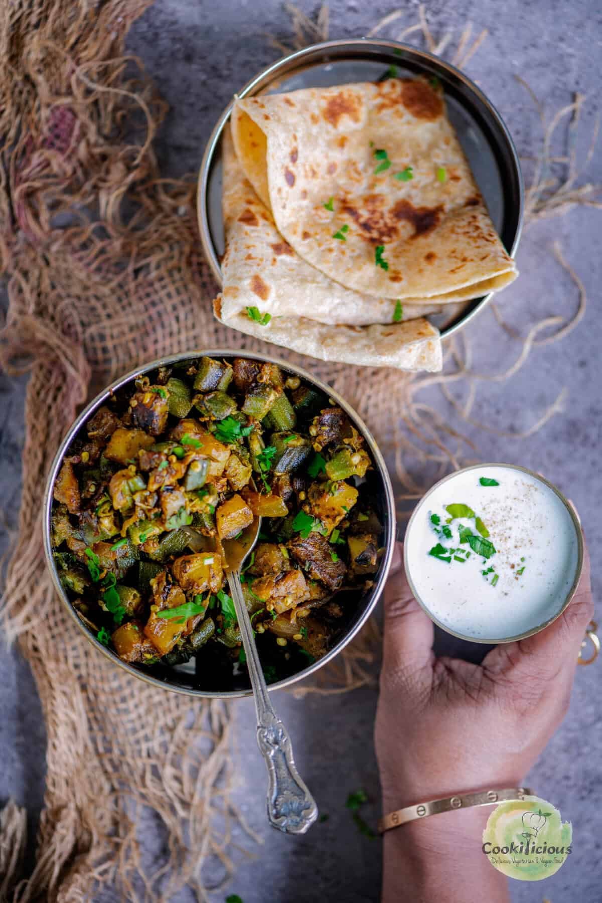 Dry Aloo Bhindi stir-fry with turmeric, cumin, and coriander, topped with fresh cilantro for a homestyle finish.