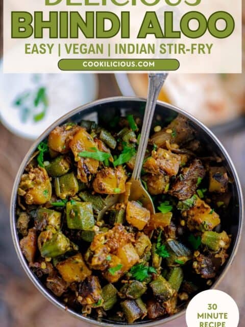 Overhead shot of Aloo Bhindi sabzi in a bowl, highlighting the texture, spices, and fresh herbs and text at the top and bottom.