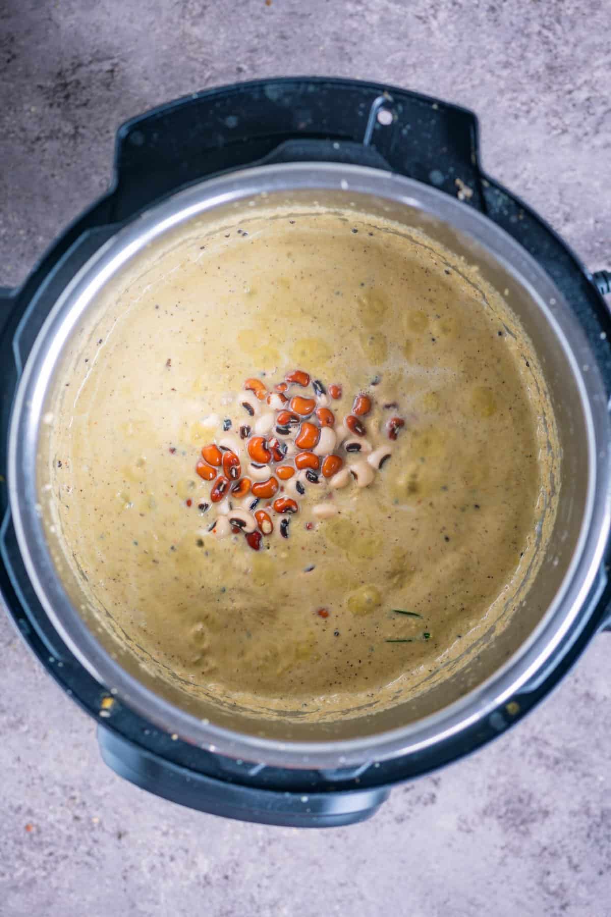 Soaked black-eyed peas and kidney beans added to the coconut spice base in the Instant Pot.