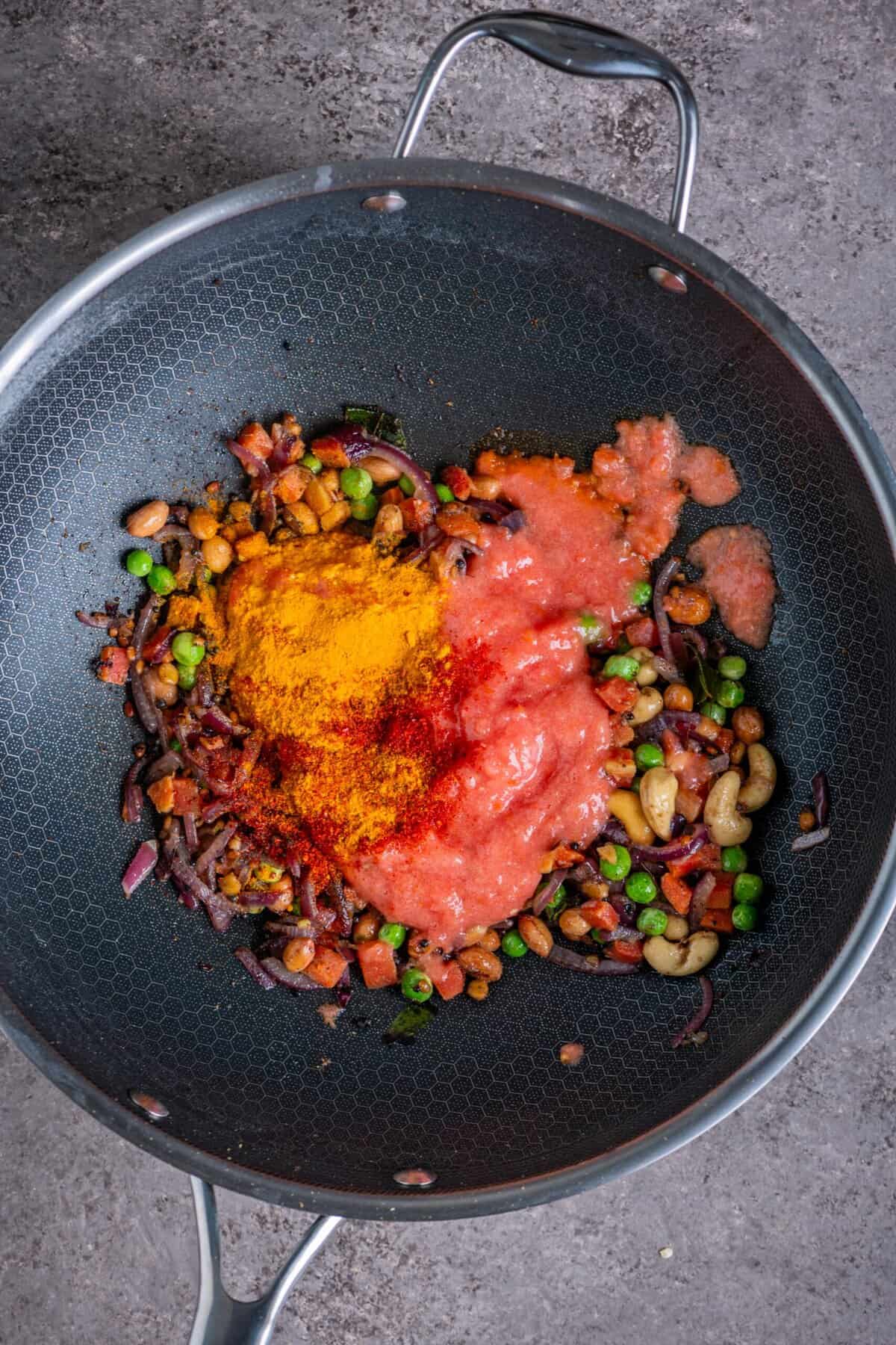Tomato puree cooking with spices to make base for tomato rava upma.