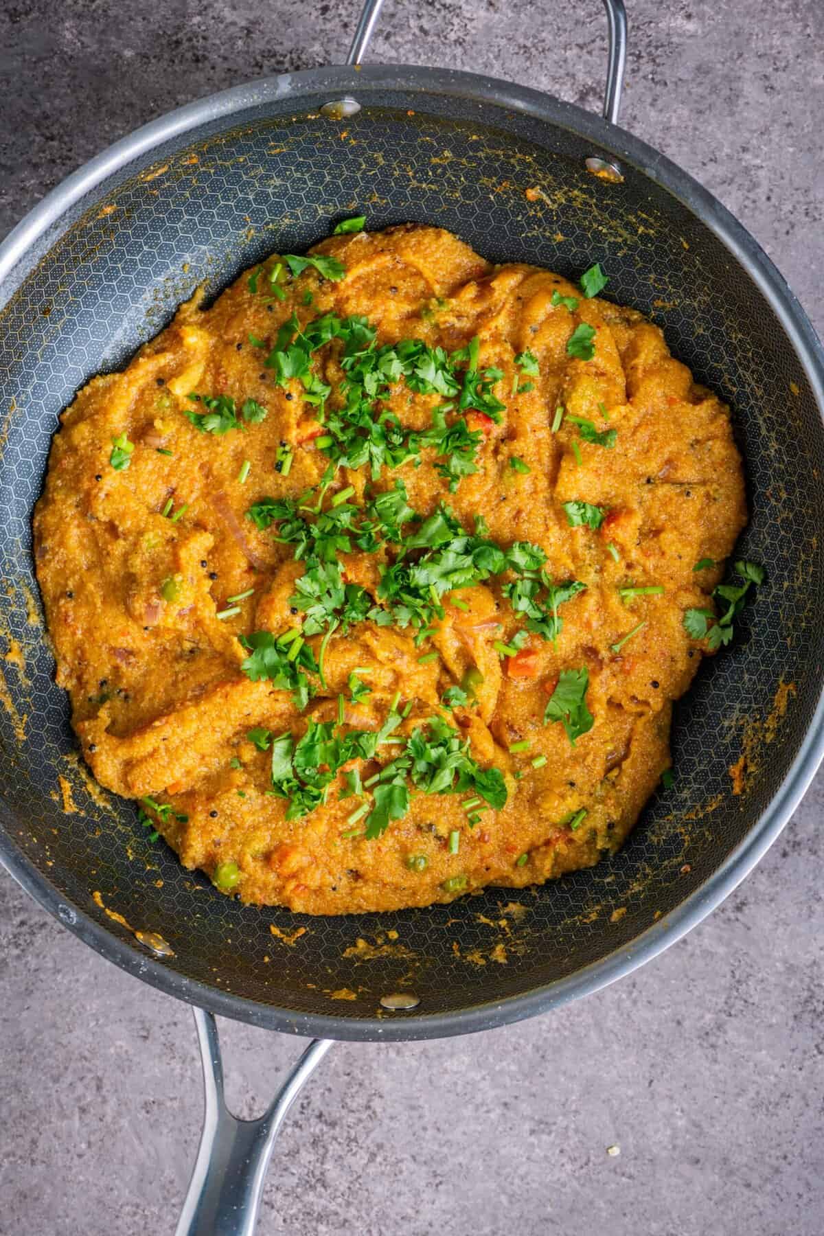 Finished tomato rava upma garnished with cilantro ready to serve.