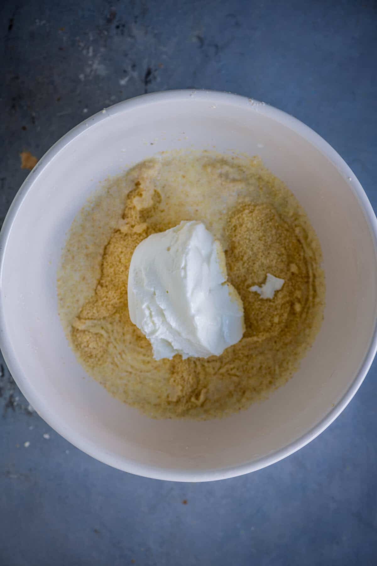 Adding yogurt to rava and milk mixture for eggless cupcakes.