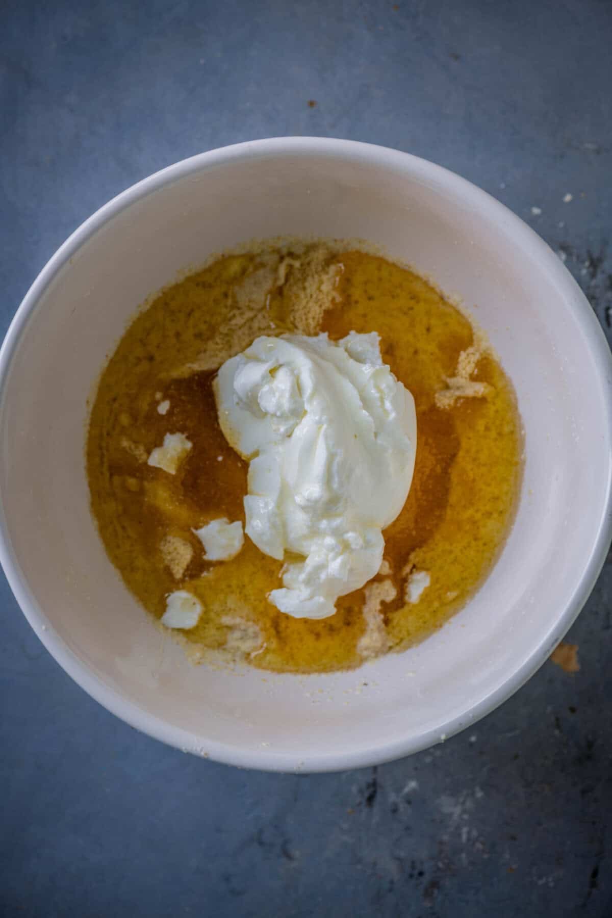 Adding oil to gulab jamun cupcake batter.