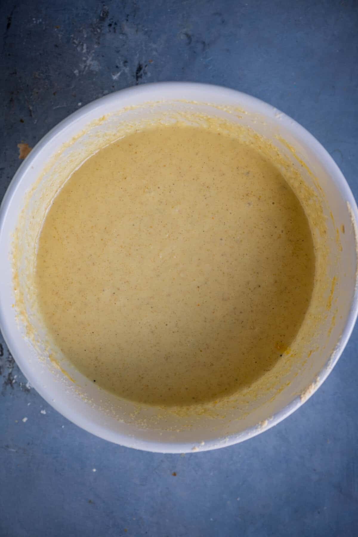 Mixed gulab jamun cupcake batter with smooth, pourable consistency.