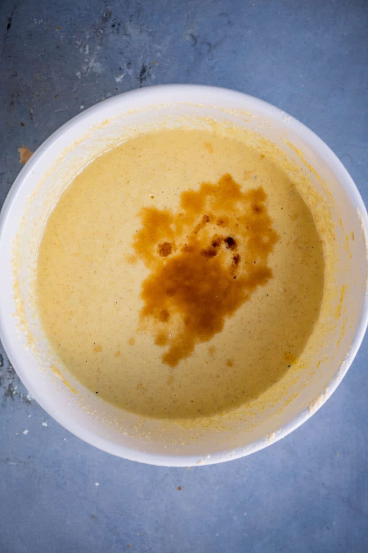 Adding vanilla extract to gulab jamun cupcake batter.