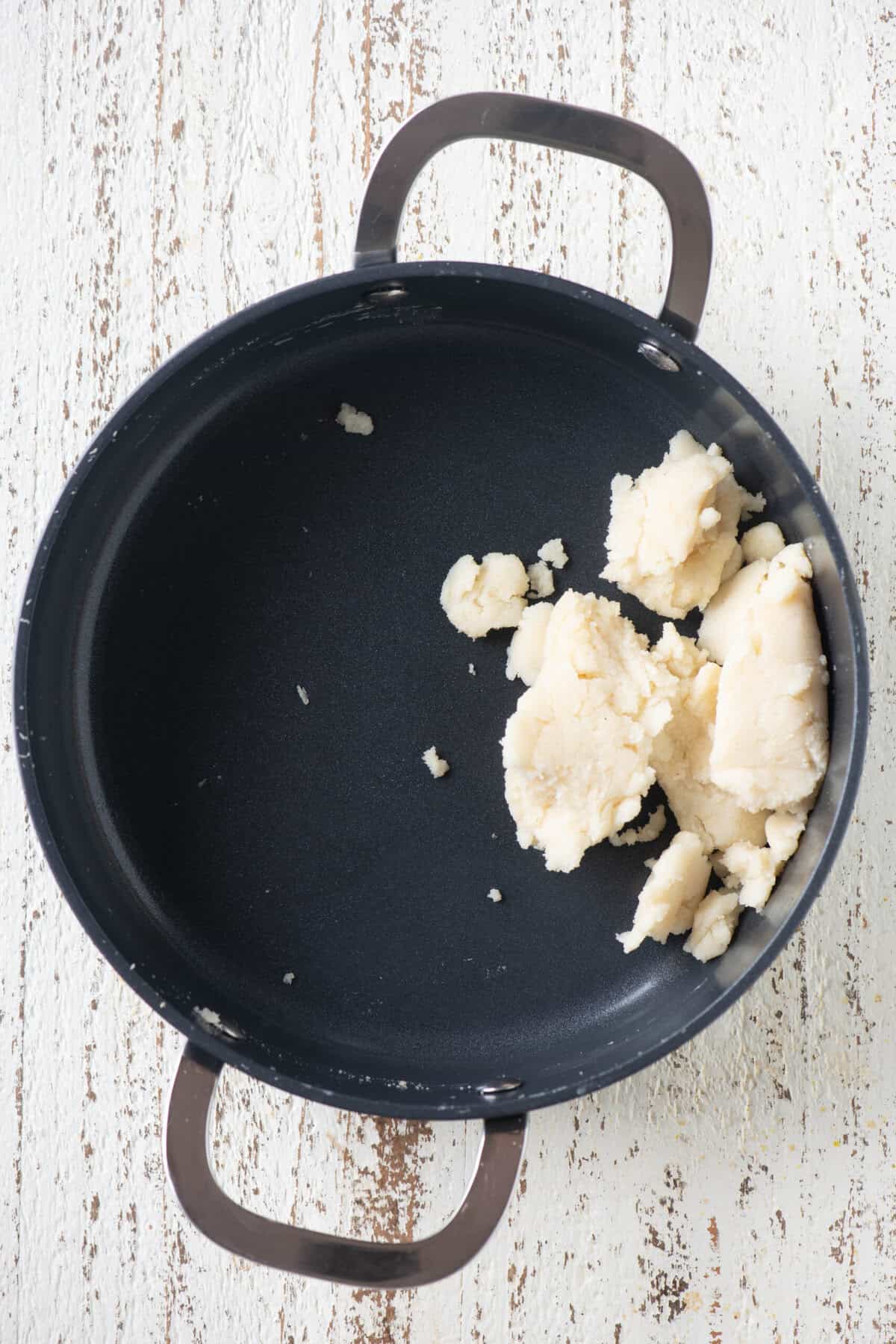 Rava mixture cooked down to a khoya-like texture in the pan.