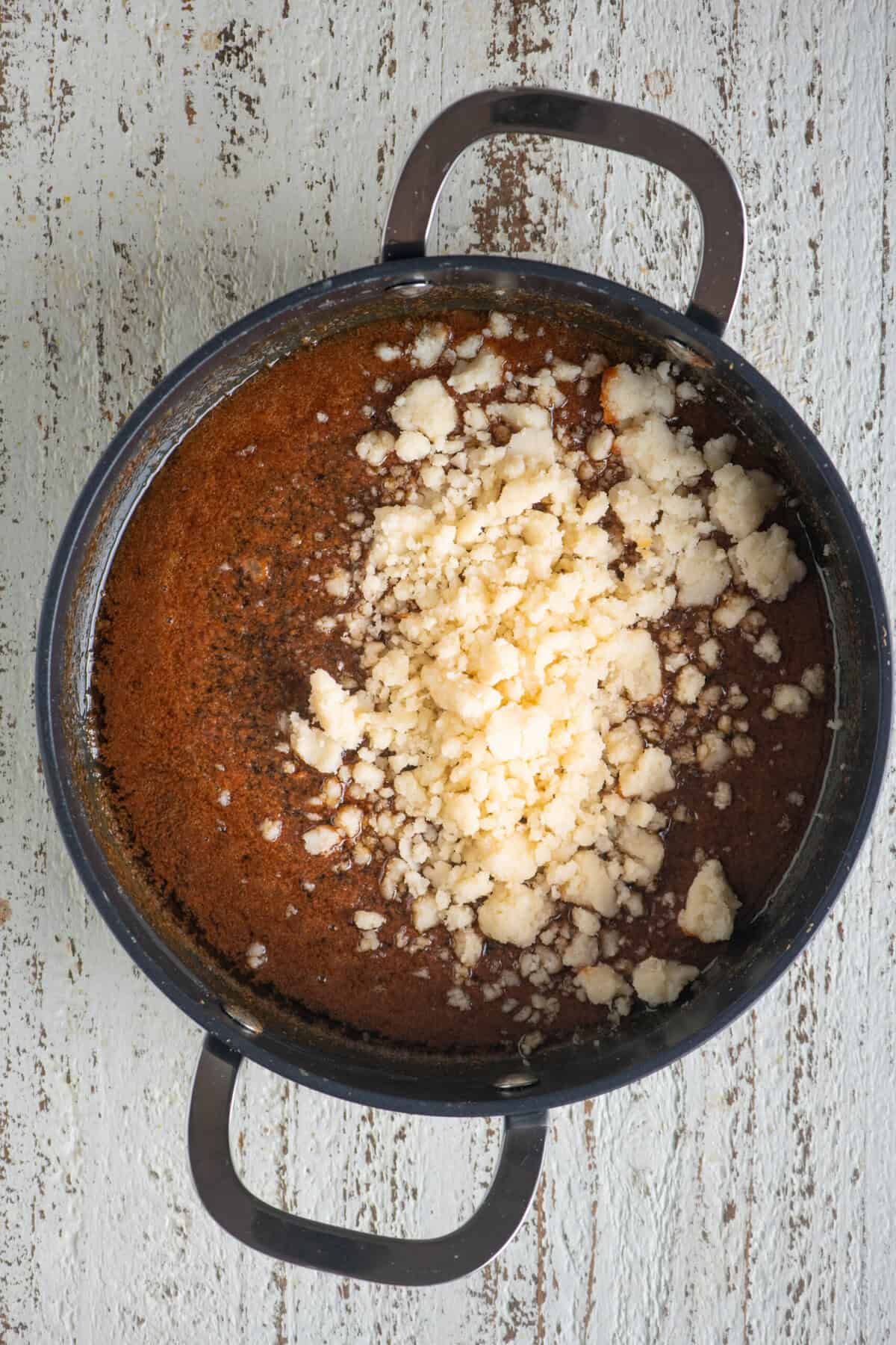 Cooked rava mixture added to the caramel milk base.