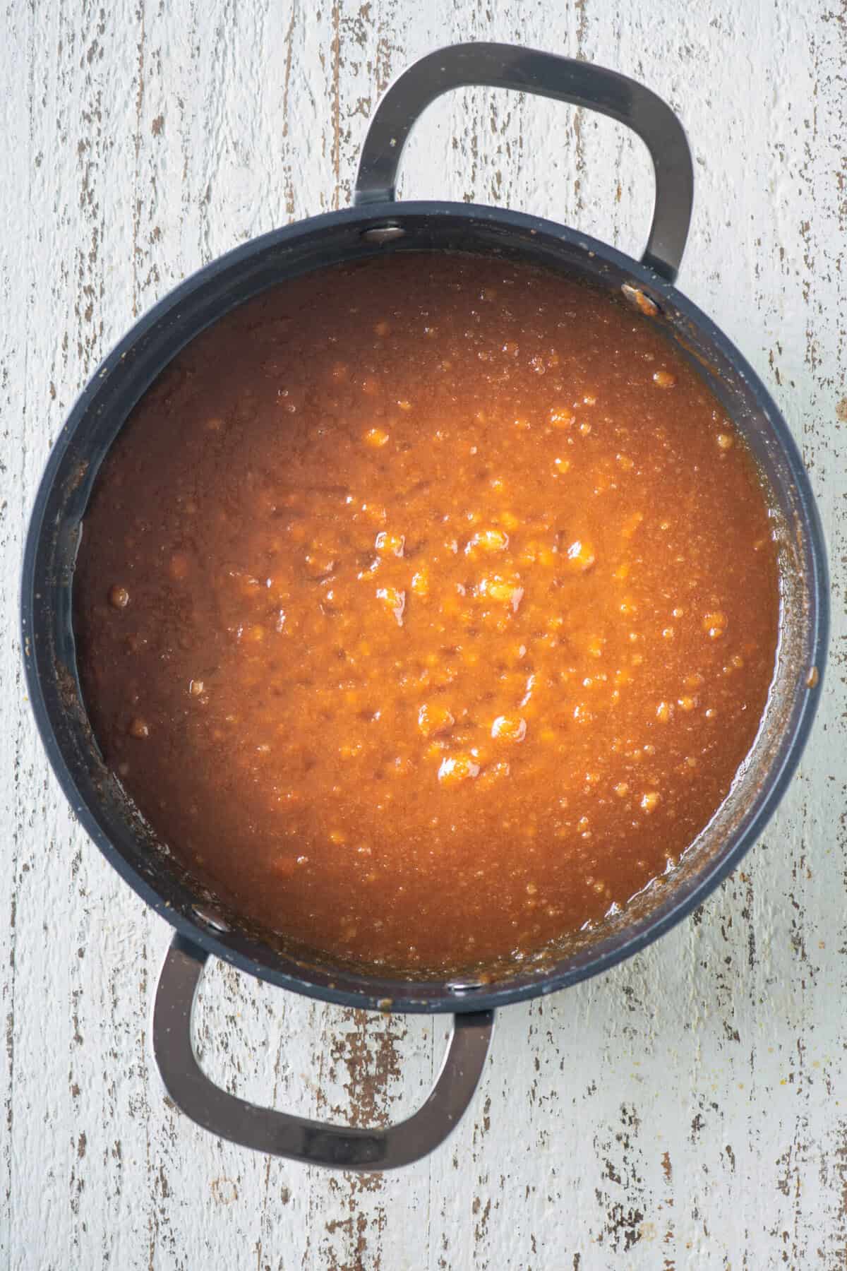 Rava mixture blending smoothly into the caramel.
